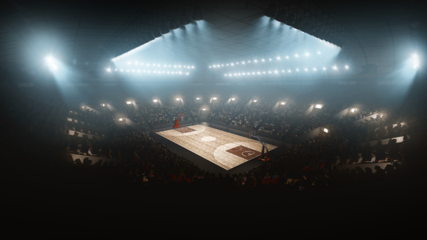 Picture of basketball court with stadium lights shining on the court.