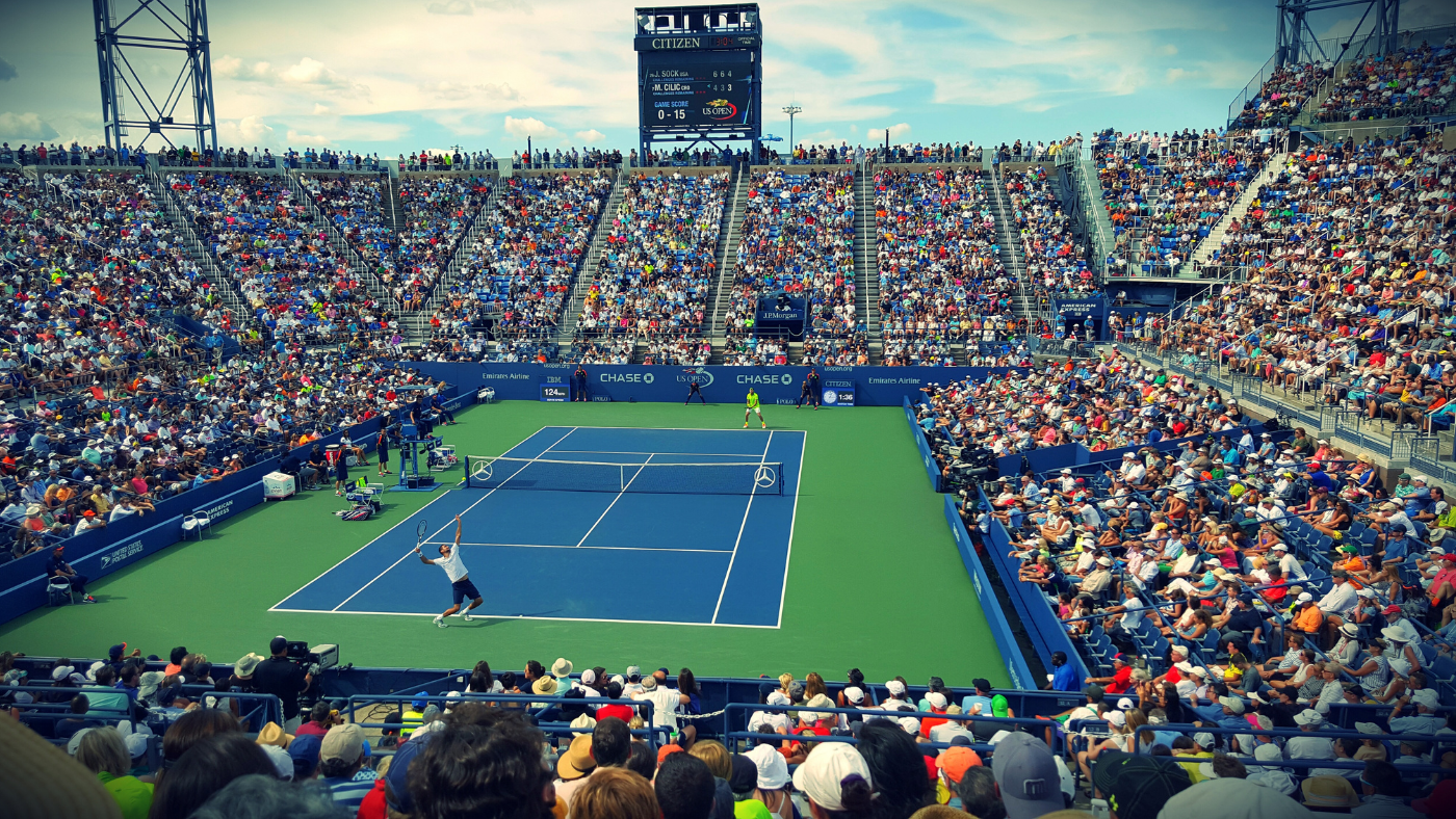 Tennis stadium packed full of fans.