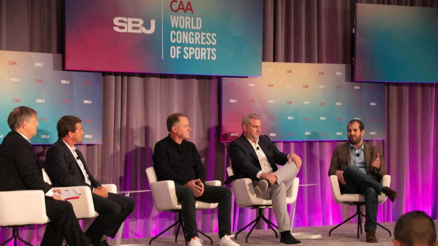 Photograph from a panel session at the CAA World Congress of Sport event featuring Rick Cordella President, Sports Programming NBC Sports and Peacock, ESPN President, Programming & Original Content Burke Magnus, FOX Sports President and COO Mark Silverman and legendary moderator, Media Reporter John Ourand Sports Business Journal