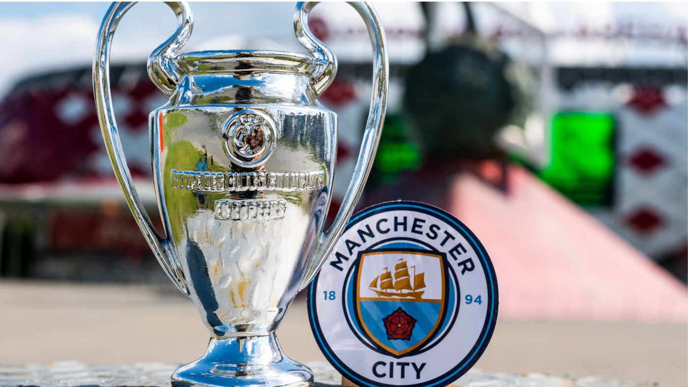 Champions League trophy next to a logo of Manchester City Football Club.