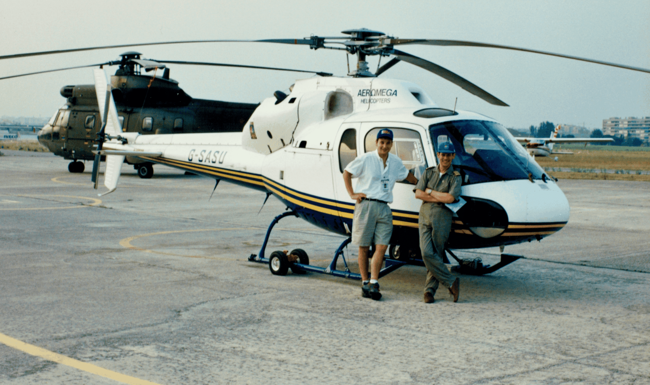 David Gavant posing for a picture in front of a helicopter at the 1992 Barcelona Olympics.