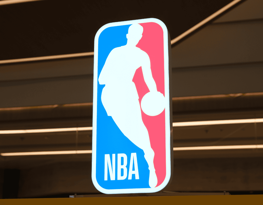 NBA logo in the foreground of brownish, neon lights